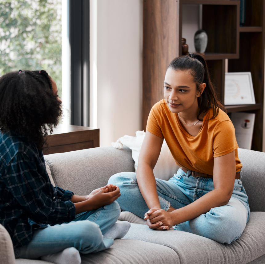 girl on couch speaking to someone